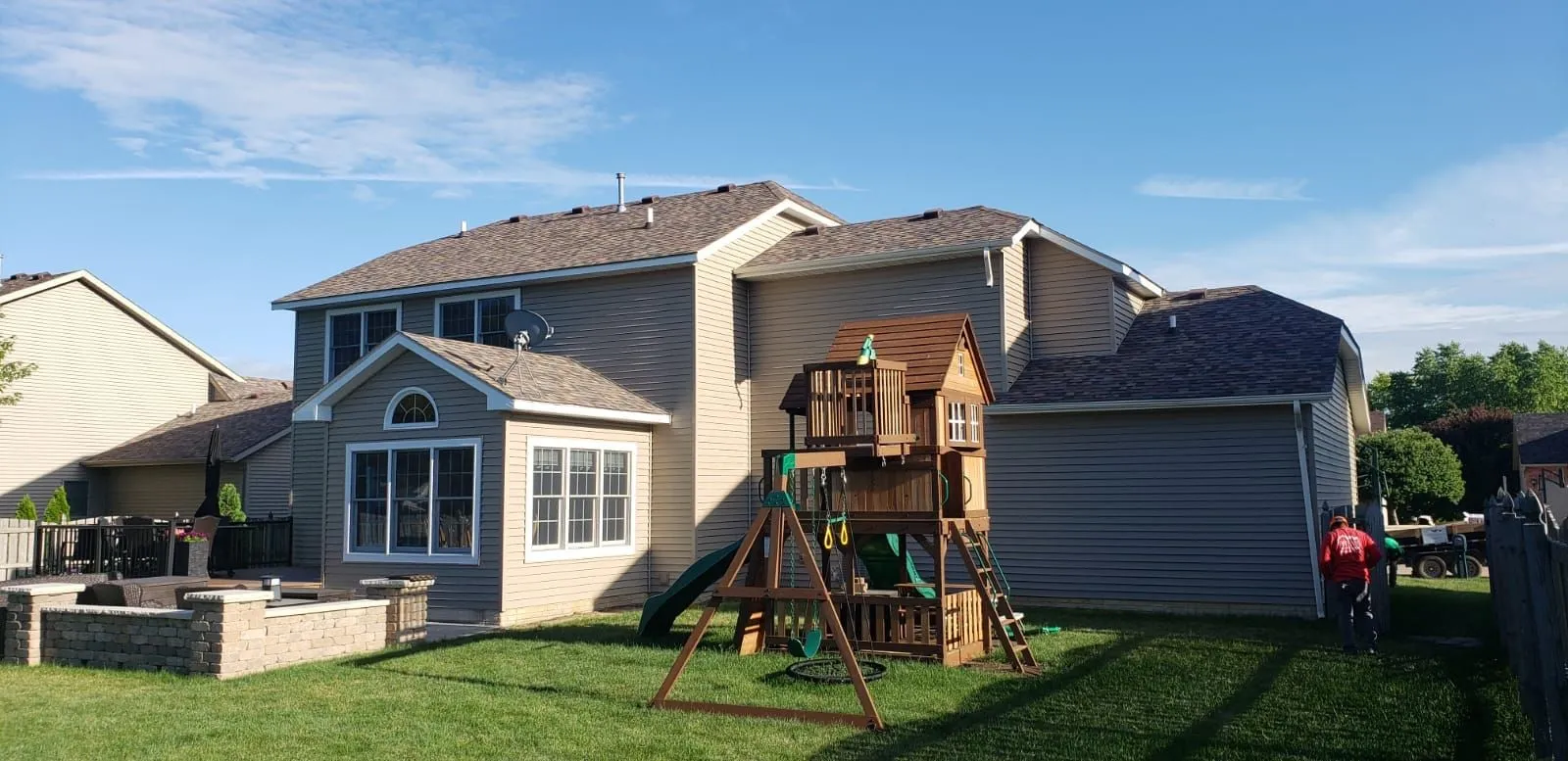 A large house with a playground in front of it.
