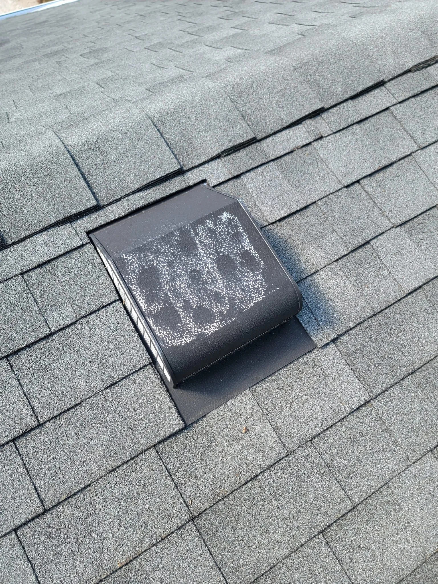 Roof vent marked with chalk during a hail damage inspection