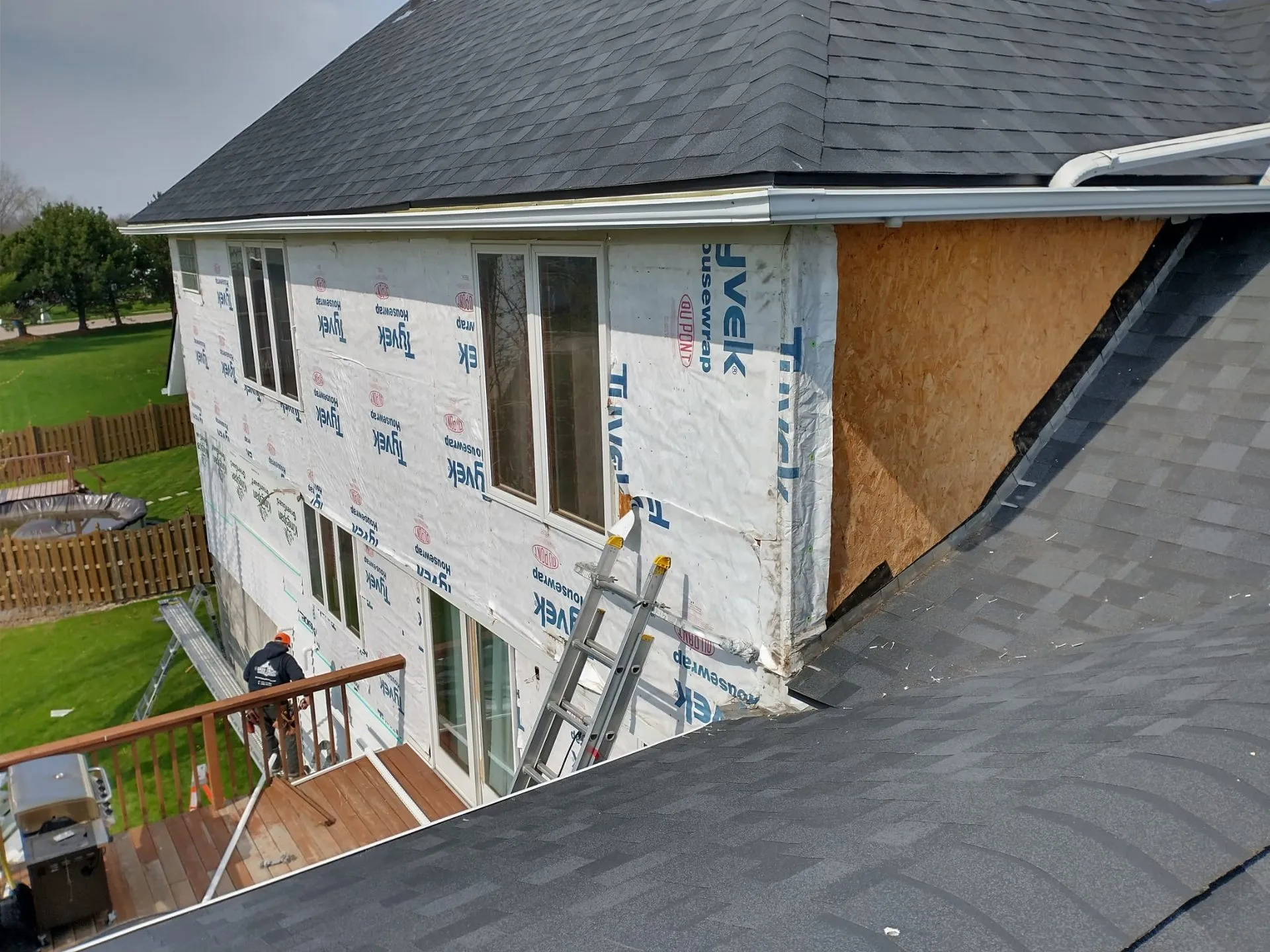 Two-story home wrapped in Tyvek house wrap during a siding replacement